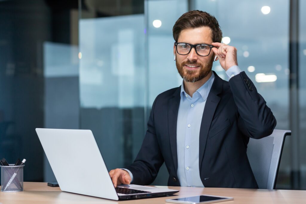 Criminal defense lawyer listening to legal podcasts on headphones while reviewing case files at a desk