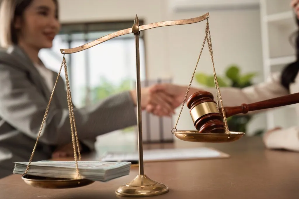 Legal marketing strategy meeting with lawyer and businesswoman shaking hands in modern office