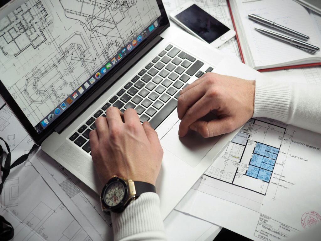 Business desk with laptop and financial documents showing law firm marketing budget waste
