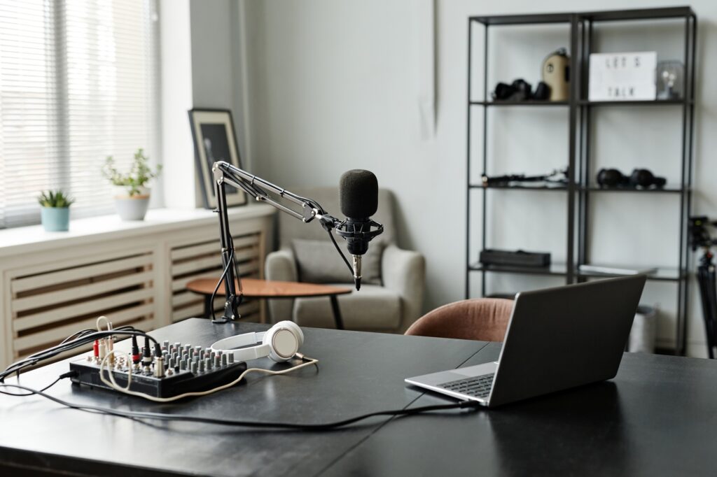 Lawyer recording a podcast episode in a professional studio with microphone and headphones for legal content marketing